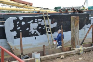 Richard Weekes paints a leeboard in drydock